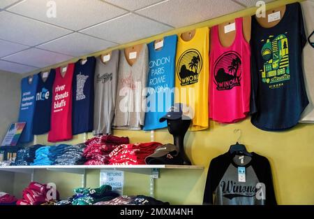 Colorful row and shelves of T-shirts for sale at the Winona Visitor Center in Winona, Minnesota USA. Stock Photo