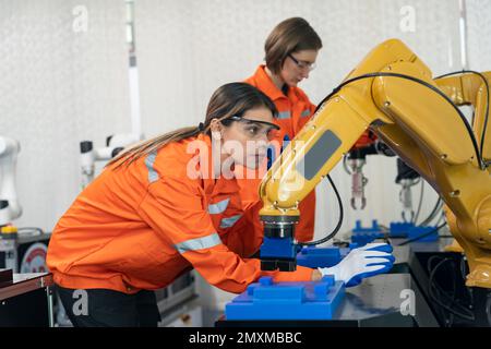 Engineer check and control welding robotics automatic arms machine in intelligent factory automotive industrial with monitoring system software. Digit Stock Photo