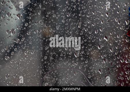 drops of water on a glass window after rain as a background Stock Photo