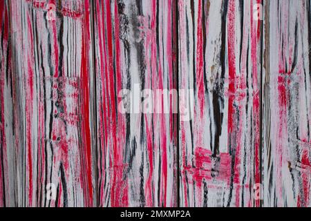 old wooden fence painted in white-red paint Stock Photo
