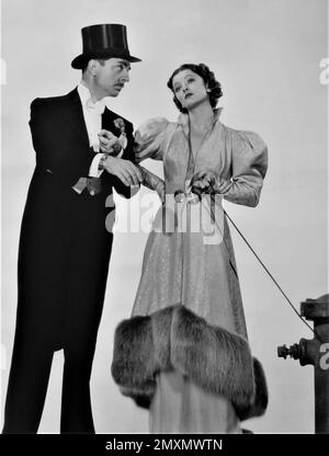 WILLIAM POWELL as Nick Charles and MYRNA LOY as Nora Charles publicity portrait for AFTER THE THIN MAN 1936 director W.S. VAN DYKE story Dashiell Hammett wardrobe Dolly Tree producer Hunt Stromberg Metro Goldwyn Mayer (MGM) Stock Photo