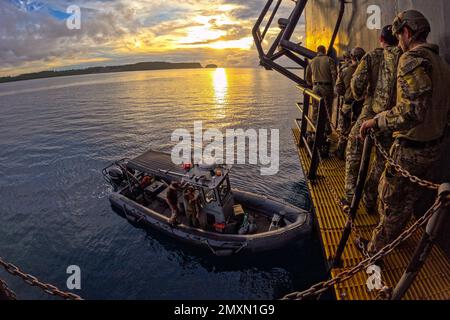 Santa Rita, Guam. 11th Jan, 2023. Sailors assigned to Explosive Ordnance Disposal Mobile Unit (EODMU) 5 conduct an at sea damage repair exercise involving a simulated explosive hazard aboard the USNS Sgt. William R. Button (T-AK 3012) as part of an EODMU platoon certification. EODMU 5 is assigned to Commander, Task Force 75, which executes command and control of assigned Navy Expeditionary Combat Forces in the 7th Fleet area of operations. They plan and execute Naval Construction, Expeditionary Logistics, Explosive Ordnance Disposal, Maritime Expeditionary Security, and Exploitation Forces Stock Photo