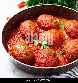 Lazy cabbage rolls stewed in sweet and sour tomato sauce. Meatballs. Beef cutlet. Stock Photo