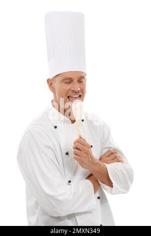 Man, chef licking wooden spoon and goofy cafe owner and small business in restaurant industry isolated on white background. Happy cook, discount deal Stock Photo