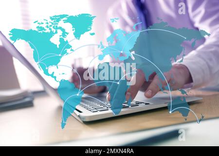 Wholesale and logistics concept. Man using laptop in office, world map illustration on foreground Stock Photo
