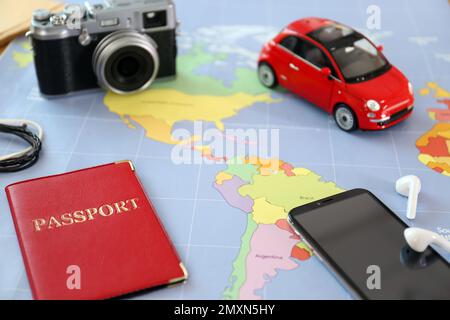 Composition with smartphone and different items on world map. Trip planning Stock Photo
