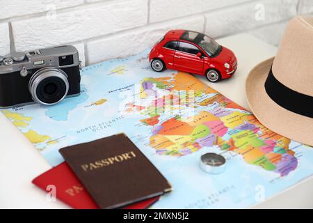 Composition with world map and different items on table. Trip planning Stock Photo
