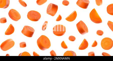 Fresh carrot slices falling on white background. Banner design Stock Photo