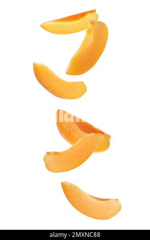 Ripe apricot slices falling on white background Stock Photo