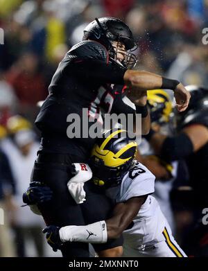 Rutgers quarterback Zach Allen (12) is hit as he throws a pass by Michigan  safety Dymonte Thomas (25) during the first half of an NCAA college  football game Saturday, Oct. 8, 2016