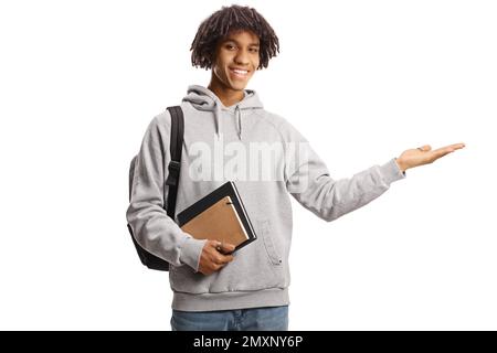 African american male student holding books and showing with hand isolated on white background Stock Photo