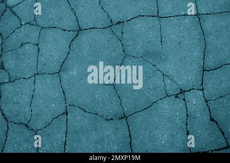 Texture of cracked asphalt with color filter, background, abstraction. Stock Photo