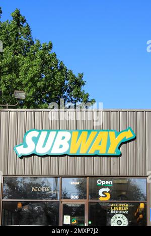A SUBWAY advertisement sign on a store with blue sky Stock Photo