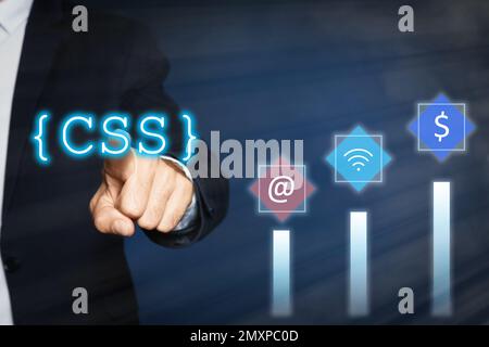 Web development. Man using button CSS on virtual screen, closeup Stock Photo