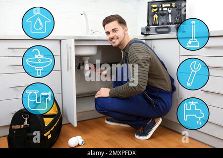 Sanitary engineering service. Professional plumber in uniform repairing kitchen sink Stock Photo