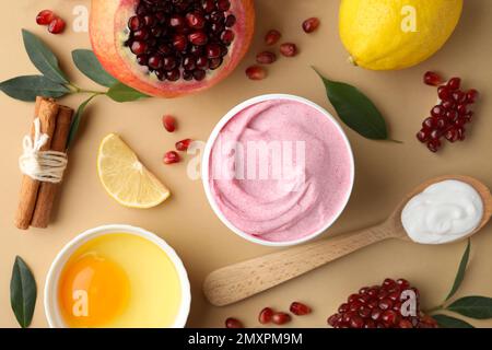 Flat lay composition with natural homemade mask, pomegranate and ingredients on beige background Stock Photo