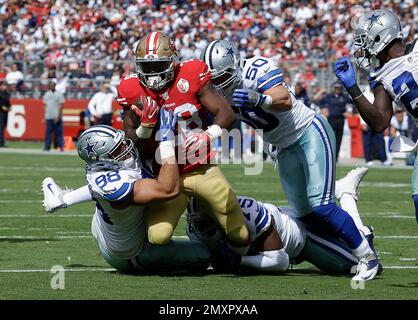 San Francisco 49ers' Sean Ryan (81) is tackled by Miami Dolphin's Channing  Crowder (52) after catching an 8 yard pass in third quarter action at  Dolphin Stadium in Miami on December 14