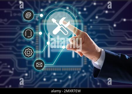 Businessman touching icon on virtual screen, closeup. Technical support Stock Photo