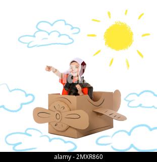 Cute little child playing in cardboard airplane on white background with illustrations Stock Photo
