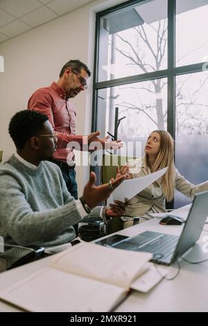 The head of the office is disappointed in his employees not doing the job correctly Stock Photo