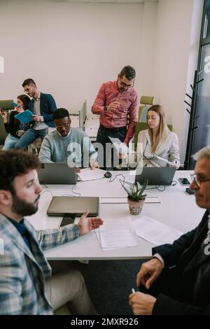Business people talking discussing and developing a new strategy for their upcoming project Stock Photo
