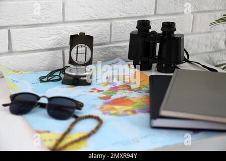 Composition with world map and different items on table. Trip planning Stock Photo