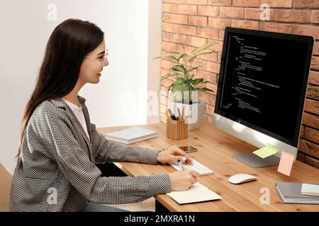 Professional programmer working with computer in office Stock Photo