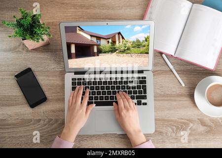 Woman choosing new house online using laptop or real estate agent working at table, top view Stock Photo