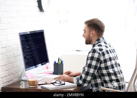 Professional programmer working with computer in office Stock Photo