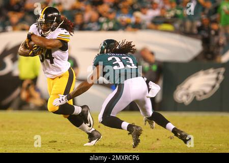 Philadelphia Eagles running back Ron Bull, center, comes splashing