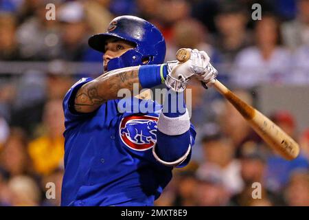 Chicago Cubs' Javier Baez, left, slides into second base safely as he hit a  one-run double as Colorado Rockies second baseman DJ LeMahieu (9) makes a  late tag during the eighth inning