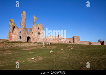 The 14th-century fortiress of Dunstanburgh Castle on the coast of Northumberland in northeast England Stock Photo