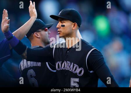 Colorado Rockies' Carlos Gonzalez is congratulated by teammates