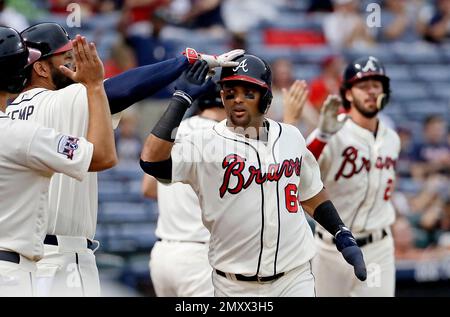 The Braves' Dansby Swanson high fives teammates prior to a game against the  Arizona Diamondbacks on Monday, Aug…