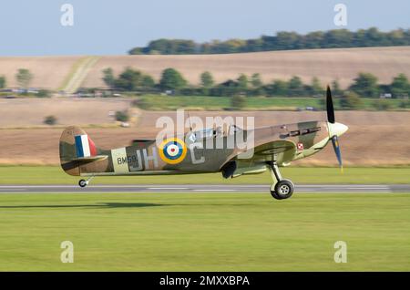 Spitfire Mk VB BM597 of Duxford's Historic Aircraft Collection landing on grass. Second World War Supermarine Spitfire fighter plane in Polish marks Stock Photo