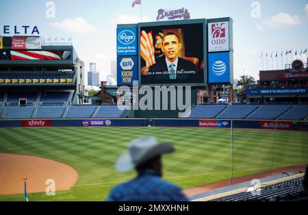 Former Atlanta Braves player and former New York Yankees manager Joe Torre  and Atlanta Braves first base coach Eric Young (2) watch a pregame ceremony  to mark the 50th anniversarsy of the