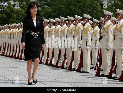 FILE - In this Aug. 4, 2016 file photo, Japan's new Defense Minister Tomomi Inada inspects a honor guard on her first day at the Defense Ministry in Tokyo. Inada, who holds her first meeting with U.S. counterpart Ash Carter on Thursday, Sept. 15, in Washington, D.C., leapfrogged over more senior lawmakers to the defense post in a Cabinet reshuffle on Aug. 3. The 57-year-old lawyer has attracted attention for questioning mainstream accounts of Japanese atrocities during World War II and the fairness of the postwar Tokyo war crimes trials. (AP Photo/Shuji Kajiyama, File)
