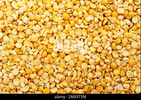 background with grains of split dried yellow peas Stock Photo