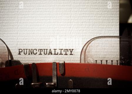 Punctuality word written with a typewriter. Stock Photo