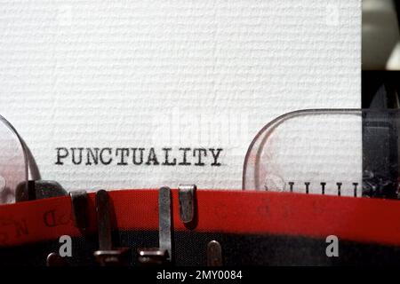 Punctuality word written with a typewriter. Stock Photo