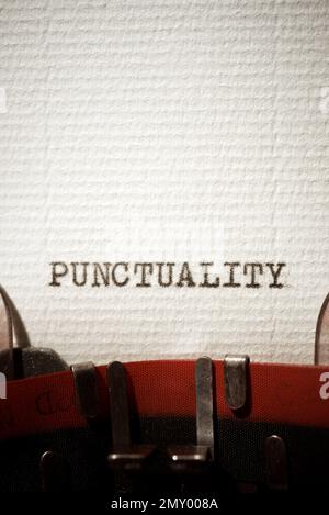 Punctuality word written with a typewriter. Stock Photo