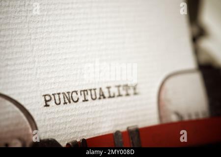 Punctuality word written with a typewriter. Stock Photo