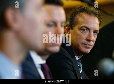 Colorado Avalanche center Joe Sakic, right, hugs retired goalie Patrick Roy  as team owner E. Stanley Kroenke, third from right, and Pierre Lacroix,  team president, look on after Roy's number 33 was