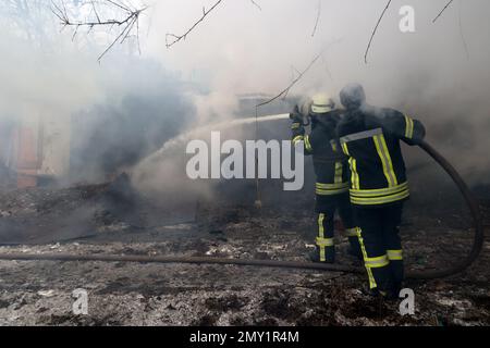 Non Exclusive: KRAMATORSK, UKRAINE - FEBRUARY 2, 2023 - Firefighters work to put out a fire after a rocket attack of Russian troops, Kramatorsk, Donet Stock Photo