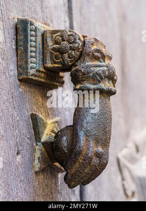 Metal knocker on old wooden door Stock Photo