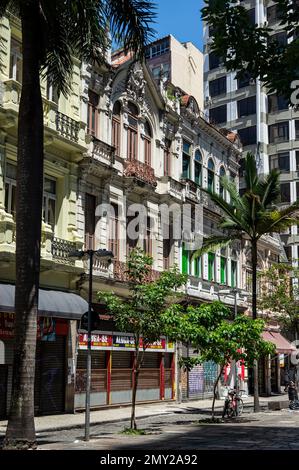 Facade of classic vintage buildings side by side located at Uruguaiana street in the populated Centro district under summer morning sunny blue sky. Stock Photo