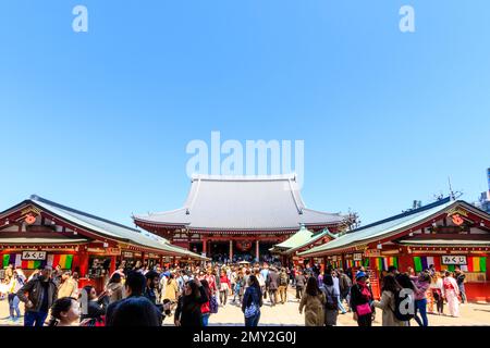 Tokyo, Asakusa shrine and Sensoji temple. Tourists filling the courtyard in front of the incense burner and the main hall. Blue sky, negative space. Stock Photo