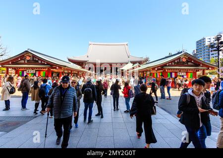 Tokyo, Asakusa shrine and Sensoji temple. Tourists filling the courtyard in front of the incense burner and the main hall. Blue sky, negative space. Stock Photo