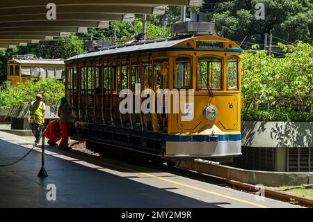 The yellow Santa Teresa tramcar number 16 being checked by station workers before passengers get on board and depart heading Largo dos Guimaraes stop. Stock Photo