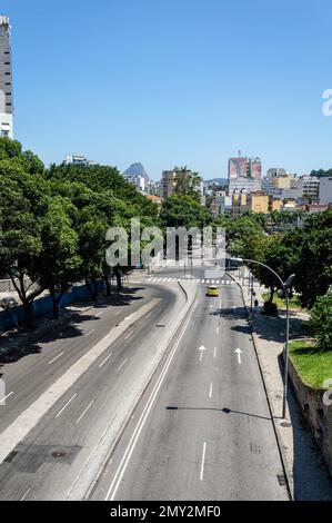 The empty Republica do Paraguai avenue saw from over Santa Teresa tram viaduct in Centro district under summer afternoon sunny clear blue sky. Stock Photo